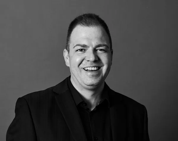 Black-and-white headshot of Dewaldt du Plessis